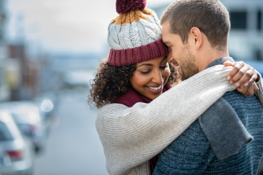 A couple embraces while smiling on one of the best romantic getaways in Ohio